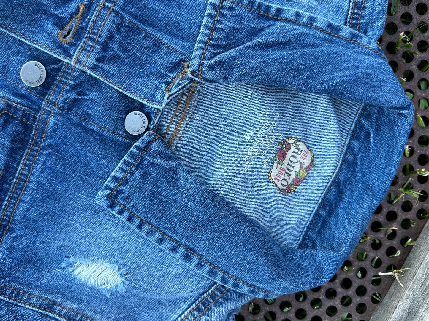 Denim jacket with Squash Blossom and tooled sides.