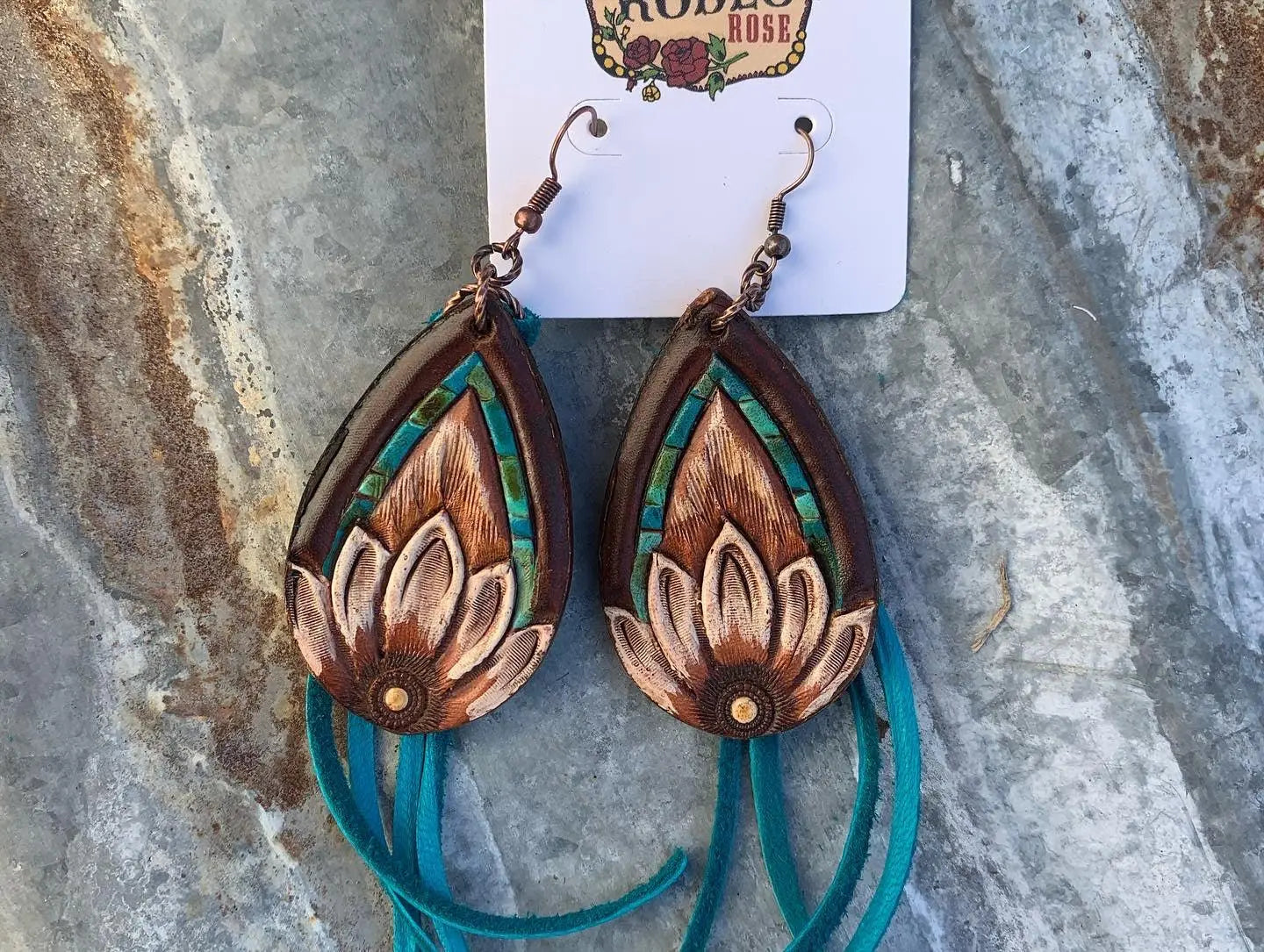 The Tad Hand Tooled Leather Earrings with Turquoise Border and Turquoise Deerskin Fringe The Rodeo Rose